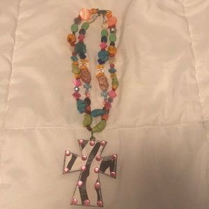 Rock necklace with rhinestone cross